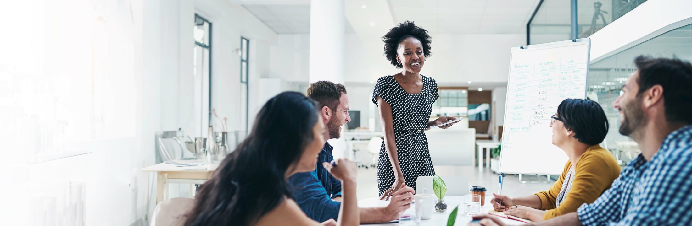 A team member presenting to colleagues in a bright office